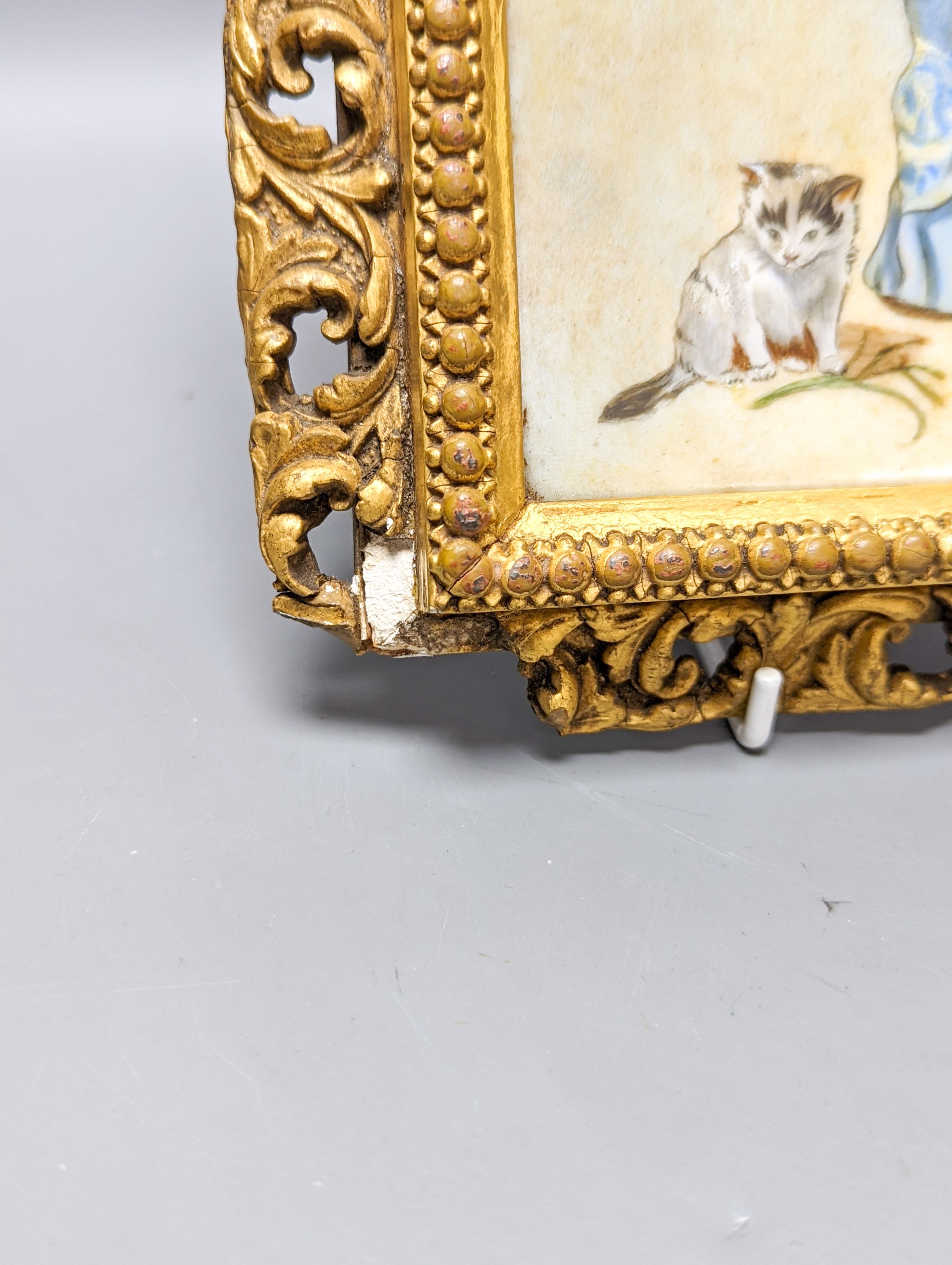 A Victorian porcelain plaque, painted with a girl with kittens, in gilt frame, 28.5 X 21 cm